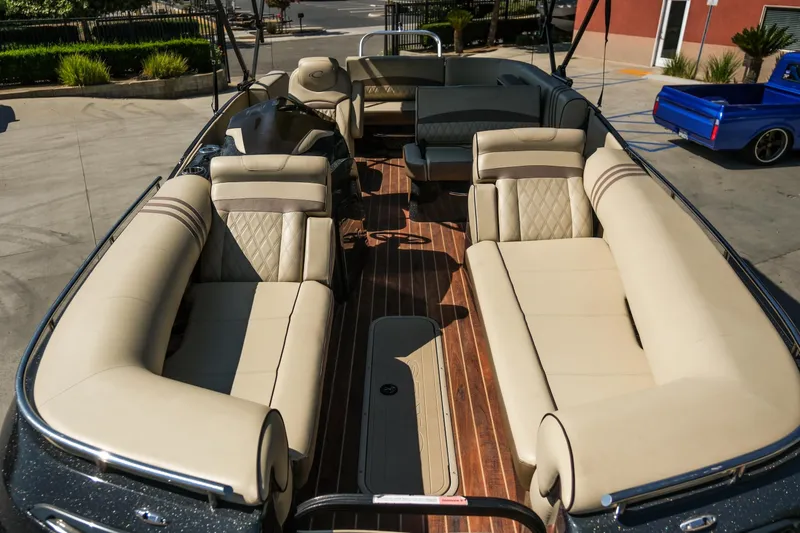 Slide: The Image of 2018 Crest Savannah 250 SLS pontoon boat with luxurious beige seating and wood flooring. - 7