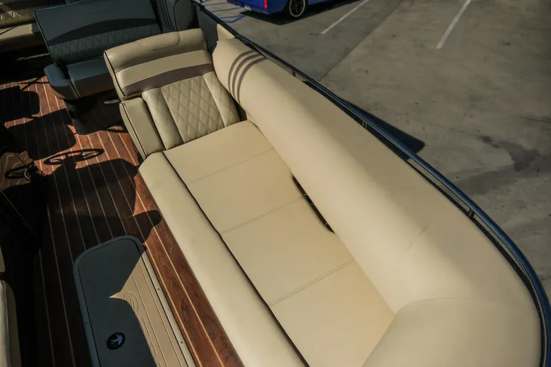 Slide: The Image of 2018 Crest Savannah 250 SLS boat interior with beige seating and wood flooring. - 9