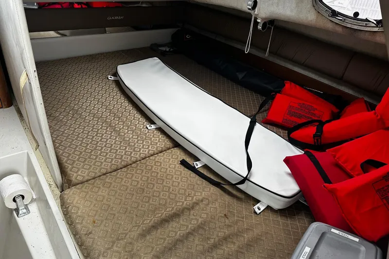 Slide: The Image of 2006 Glacier Bay 2670 boat deck with storage compartments and dual engines. - 14