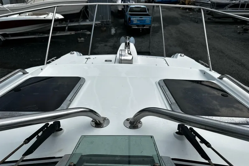 Slide: The Image of 2006 Glacier Bay 2670 boat deck with railings and hatches in a marina. - 4