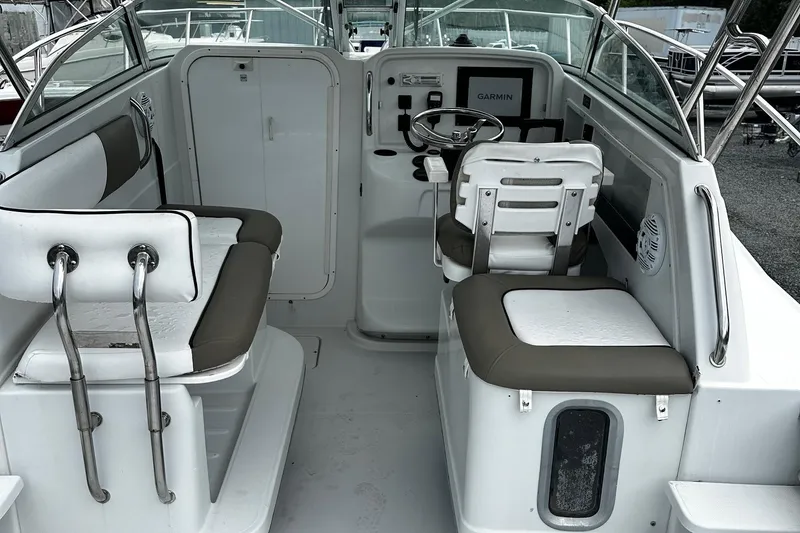 Slide: The Image of 2006 Glacier Bay 2670 boat interior with seating and steering console. - 9