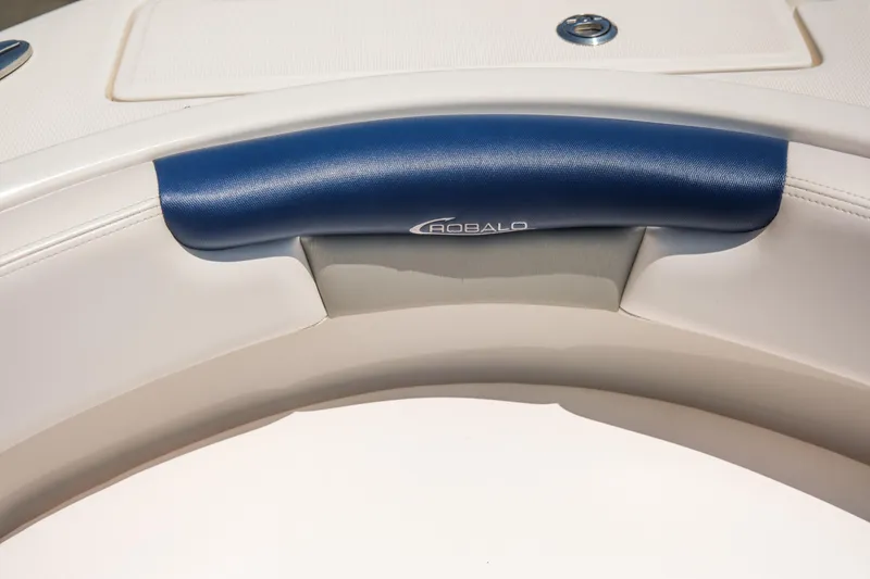 Slide: The Image of 2021 Robalo R227 Dual Console boat interior with blue and white seating. - 12