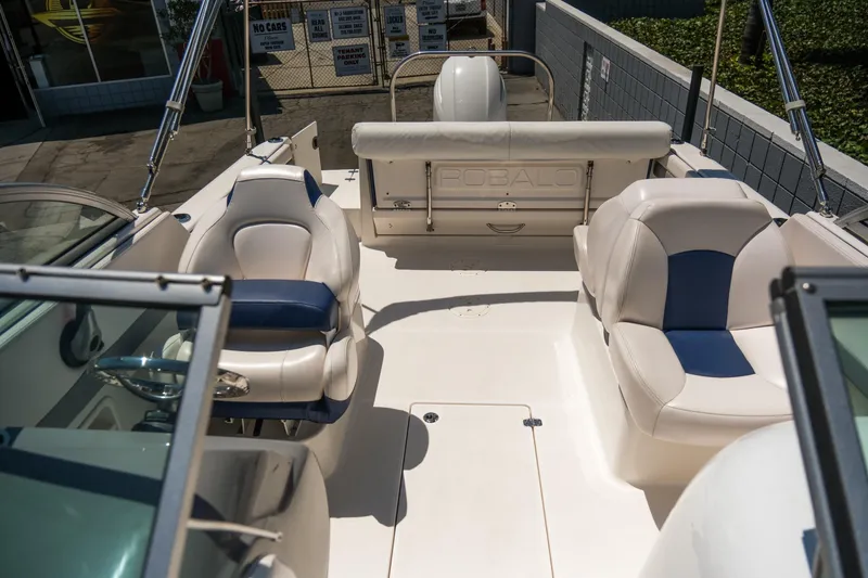 Slide: The Image of 2021 Robalo R227 Dual Console boat interior with white and blue seating. - 13
