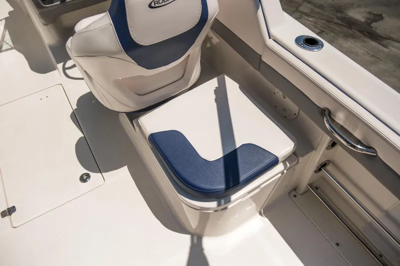 Slide: The Image of 2021 Robalo R227 Dual Console boat seating area with blue and white upholstery. - 20