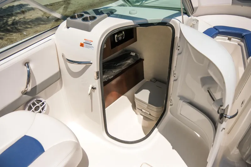 Slide: The Image of 2021 Robalo R227 Dual Console boat interior with open storage compartment and seating. - 22