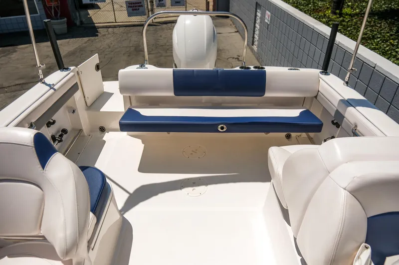 Slide: The Image of 2021 Robalo R227 Dual Console boat interior with white and blue seating. - 25