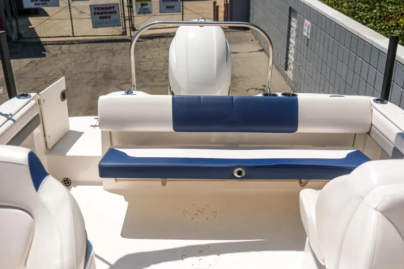 Slide: The Image of 2021 Robalo R227 Dual Console boat interior with blue and white seating. - 26