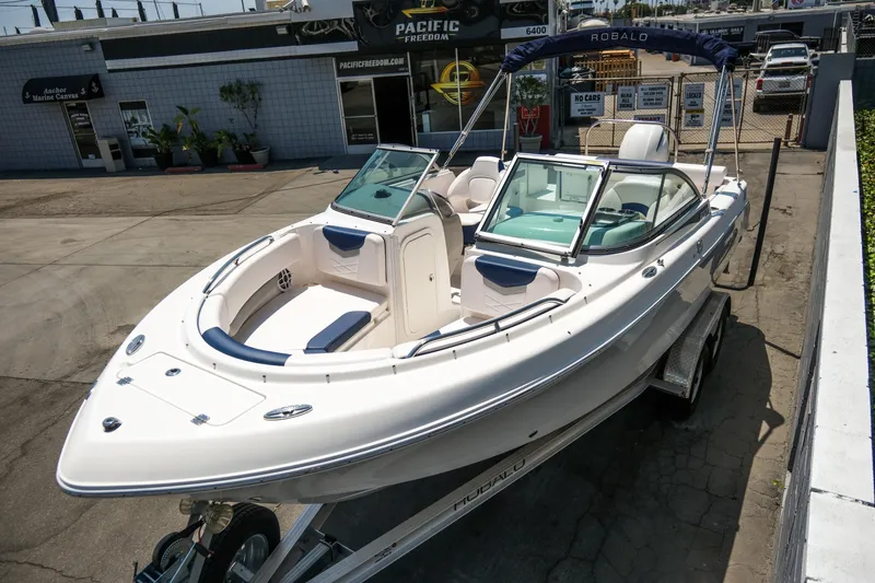 Slide: The Image of 2021 Robalo R227 Dual Console boat on trailer at a dealership. - 6
