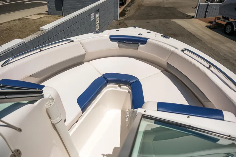 Slide: The Image of 2021 Robalo R227 Dual Console boat with spacious seating and blue accents. - 9