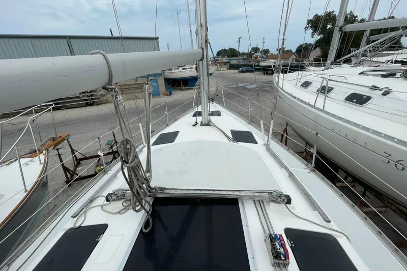 Slide: The Image of 1994 Hunter 30 sailboat on dry dock, surrounded by other boats. - 10