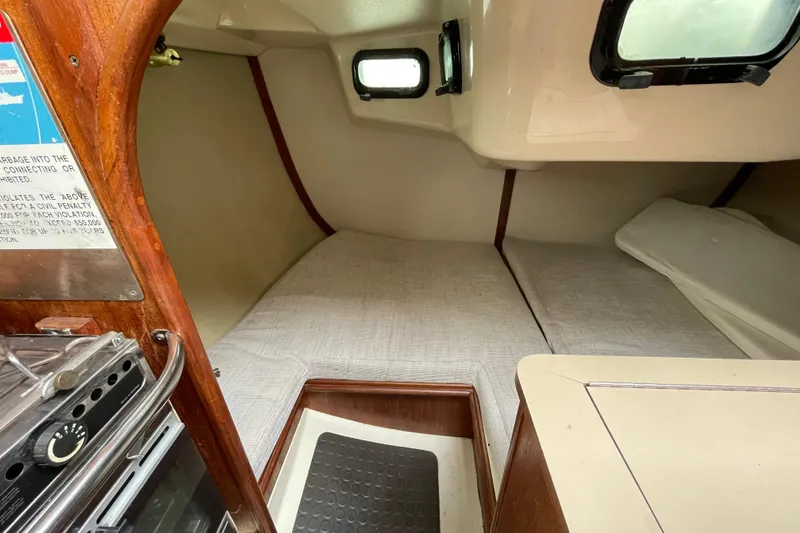 Slide: The Image of Interior cabin of a 1994 Hunter 30 sailboat with sleeping area and stove. - 14