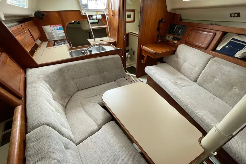 Slide: The Image of Interior of a 1994 Hunter 30 sailboat with cozy seating and wooden cabinetry. - 15