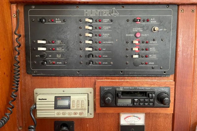 Slide: The Image of Electrical control panel on a 1994 Hunter 30 sailboat, featuring switches and gauges. - 17