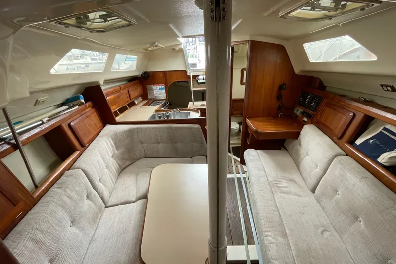 Slide: The Image of Interior of a 1994 Hunter 30 sailboat with cozy seating and wooden cabinetry. - 18