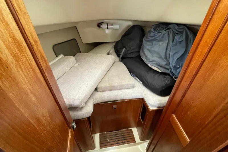 Slide: The Image of Interior cabin of a 1994 Hunter 30 sailboat with cushions and storage bags. - 19