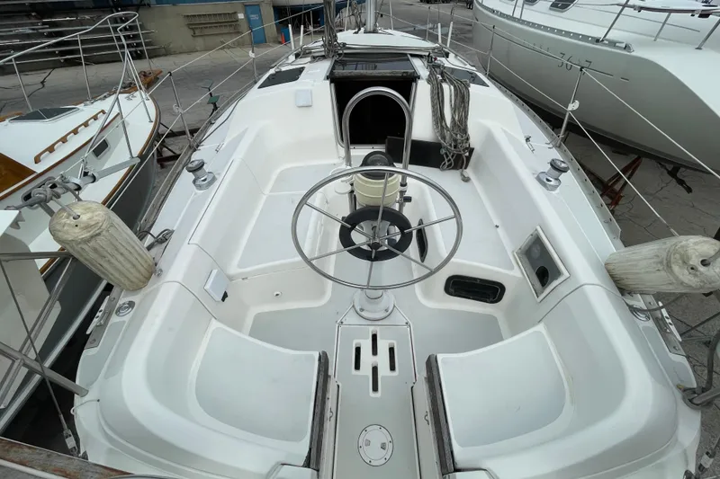 Slide: The Image of Cockpit of a 1994 Hunter 30 sailboat with steering wheel and seating. - 6