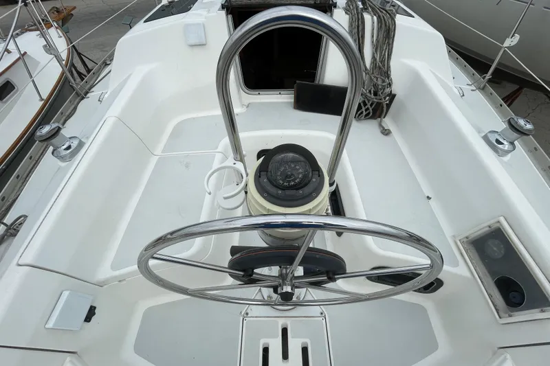 Slide: The Image of Cockpit of a 1994 Hunter 30 sailboat with steering wheel and compass. - 8