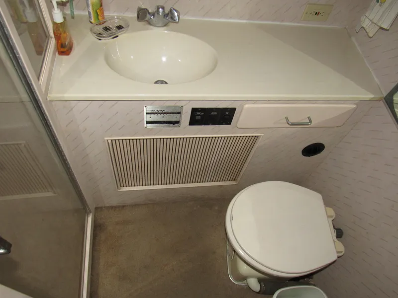 Slide: The Image of 1989 Tollycraft Sport Sedan bathroom with sink, toilet, and shower. - 10