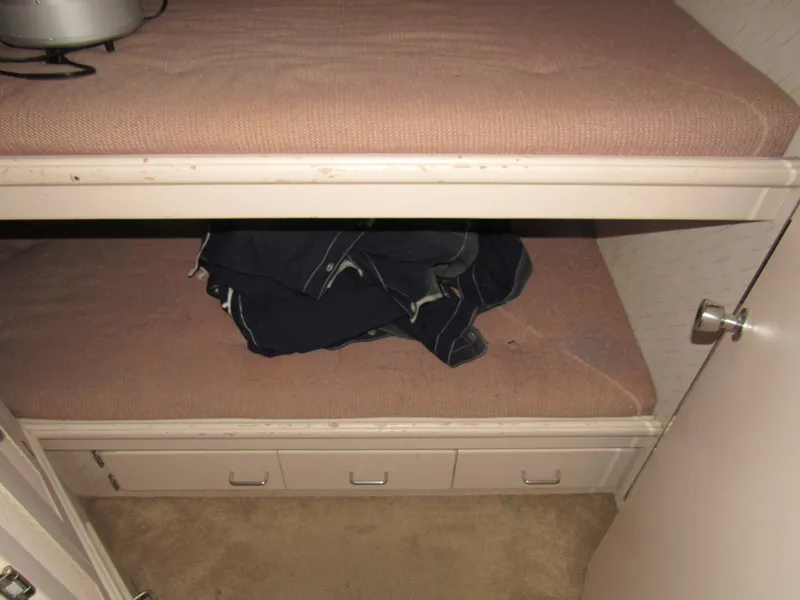 Slide: The Image of 1989 Tollycraft Sport Sedan interior with bunk beds and storage drawers. - 11