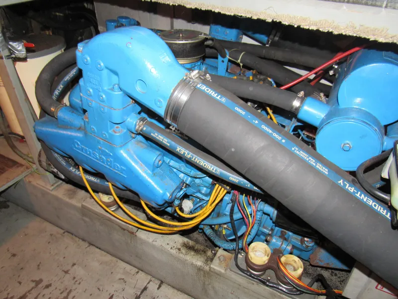 Slide: The Image of Engine compartment of a 1989 Tollycraft Sport Sedan with blue components and black hoses. - 15