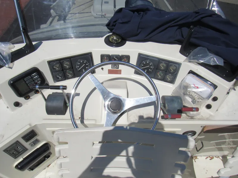 Slide: The Image of 1989 Tollycraft Sport Sedan helm with steering wheel and instrument panel. - 21