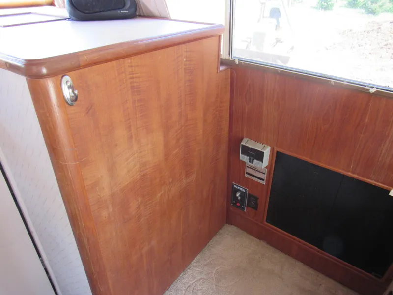 Slide: The Image of 1989 Tollycraft Sport Sedan interior with wood paneling and control panel. - 24