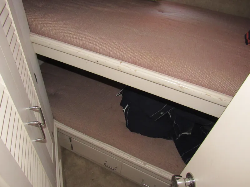 Slide: The Image of 1989 Tollycraft Sport Sedan interior with bunk beds and storage drawers. - 26