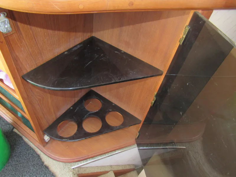 Slide: The Image of 1989 Tollycraft Sport Sedan interior with wooden shelves and cup holders. - 28