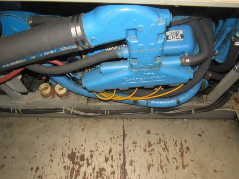 Slide: The Image of Engine compartment of a 1989 Tollycraft Sport Sedan with blue components and hoses. - 37