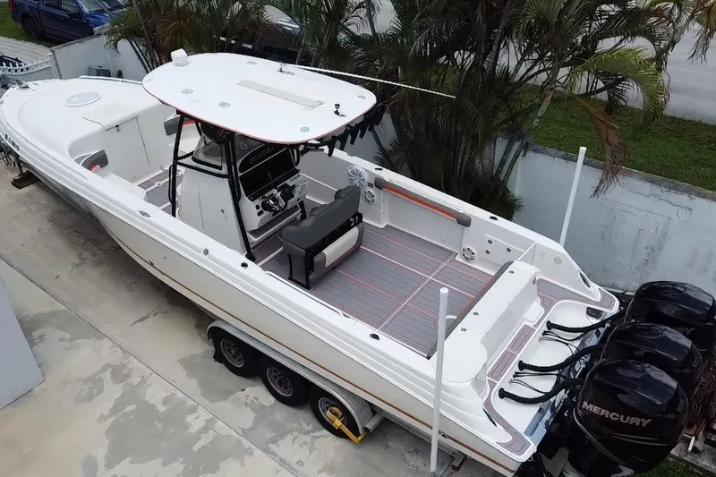 Slide: The Image of 2007 Scarab 35 Sport boat with triple Mercury engines, parked on a trailer. - 16