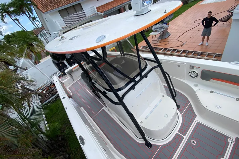 Slide: The Image of 2007 Scarab 35 Sport boat with T-top, docked near a house with palm trees. - 30