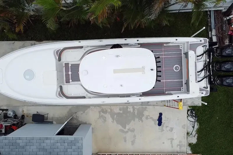 Slide: The Image of Aerial view of a 2007 Scarab 35 Sport boat docked beside a house. - 38