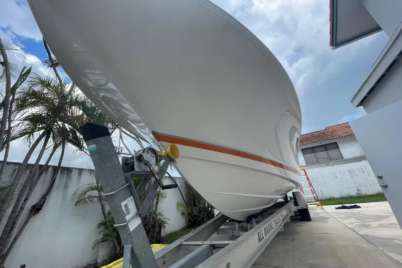 Slide: The Image of 2007 Scarab 35 Sport boat on trailer, parked outdoors with palm trees in background. - 6