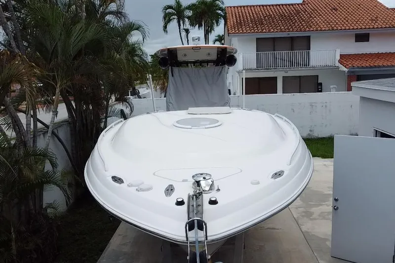 Slide: The Image of 2007 Scarab 35 Sport boat on trailer, viewed from below, with palm trees in background. - 8