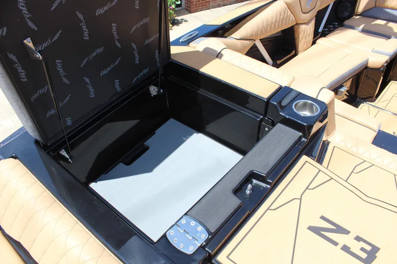 Slide: The Image of 2026 Tigé Z3 boat interior with open storage compartment and tan seating. - 10