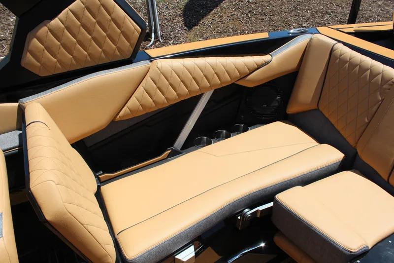 Slide: The Image of 2026 Tigé Z3 boat interior with tan quilted leather seating and cup holders. - 11