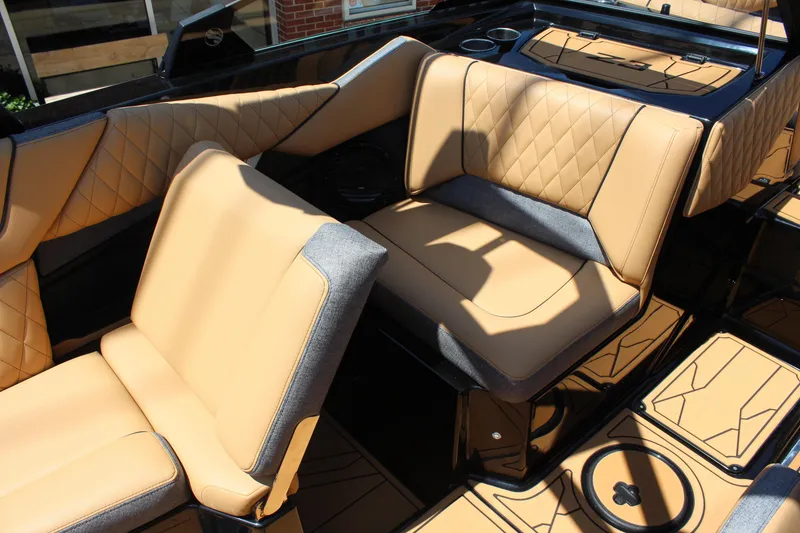 Slide: The Image of 2026 Tigé Z3 boat interior with tan and gray quilted seats, cup holders, and sleek design. - 14