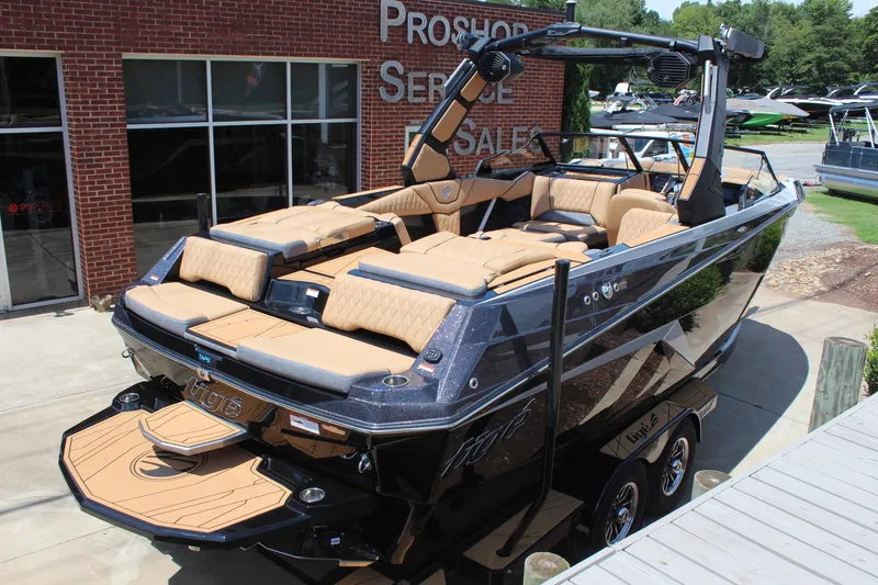 Slide: The Image of 2026 Tigé Z3 boat with luxurious seating, parked at a dealership. - 7