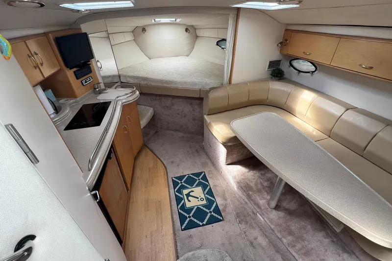 Slide: The Image of 2000 Larson 330 CABRIO interior with kitchen, seating area, and sleeping quarters. - 10