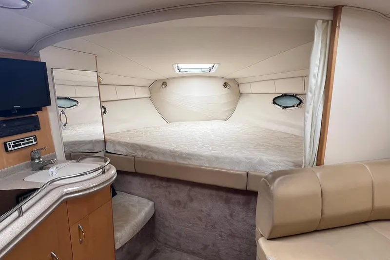 Slide: The Image of Interior of 2000 Larson 330 CABRIO boat with cozy bed and modern amenities. - 13