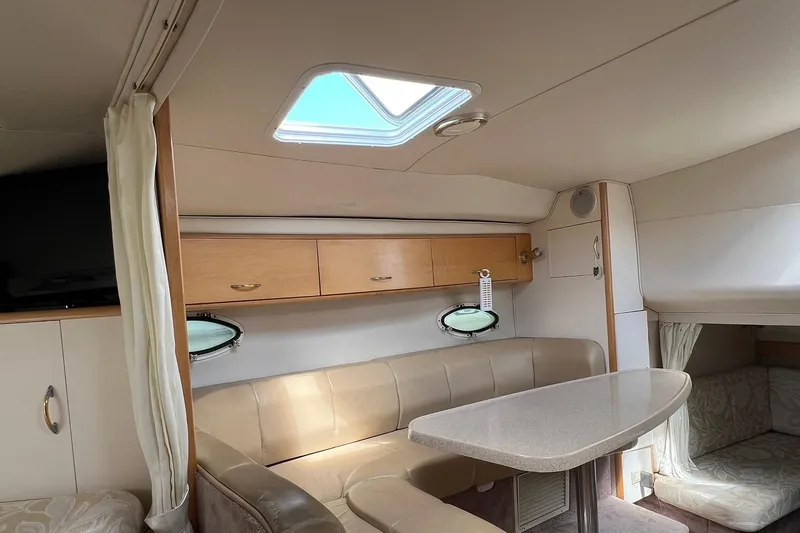 Slide: The Image of Interior of 2000 Larson 330 CABRIO boat with seating, table, and skylight. - 15