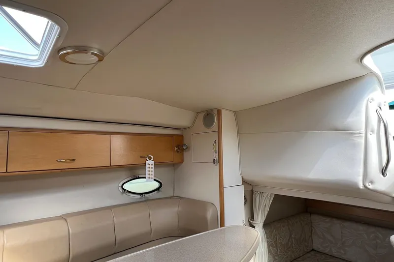 Slide: The Image of Interior of a 2000 Larson 330 Cabrio boat with seating and storage cabinets. - 18