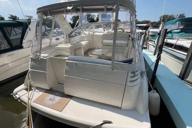 Slide: The Image of Interior detail of 2000 Larson 330 Cabrio boat, featuring woven fabric and sleek design elements. - 2