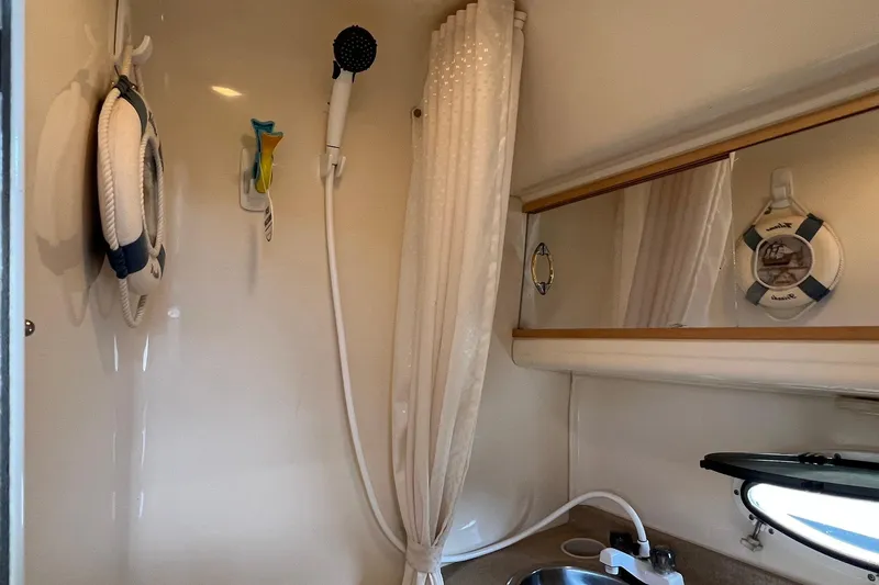 Slide: The Image of Interior of 2000 Larson 330 CABRIO boat bathroom with shower and sink. - 23