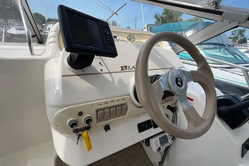 Slide: The Image of Steering console of a 2000 Larson 330 Cabrio boat with navigation equipment. - 27