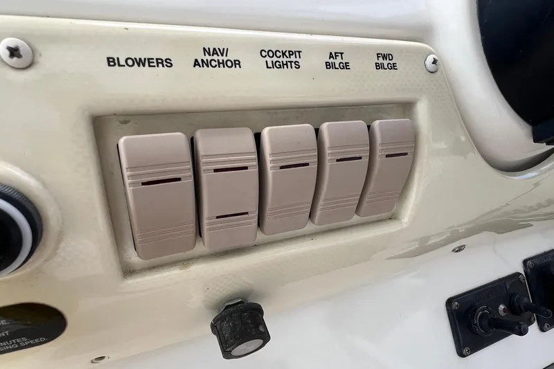 Slide: The Image of Control panel of a 2000 Larson 330 Cabrio boat with labeled switches. - 32