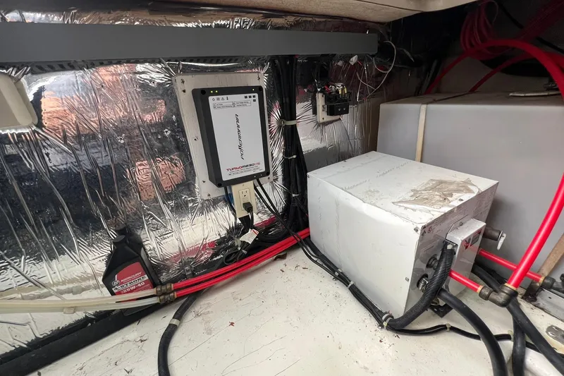 Slide: The Image of Engine room of a 2000 Larson 330 CABRIO boat with equipment and wiring. - 33