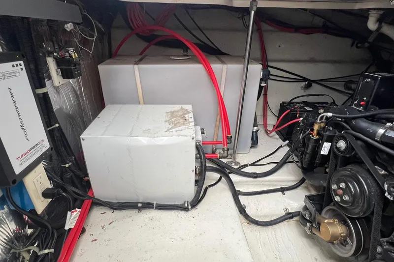 Slide: The Image of Engine room of a 2000 Larson 330 CABRIO boat with visible machinery and wiring. - 35