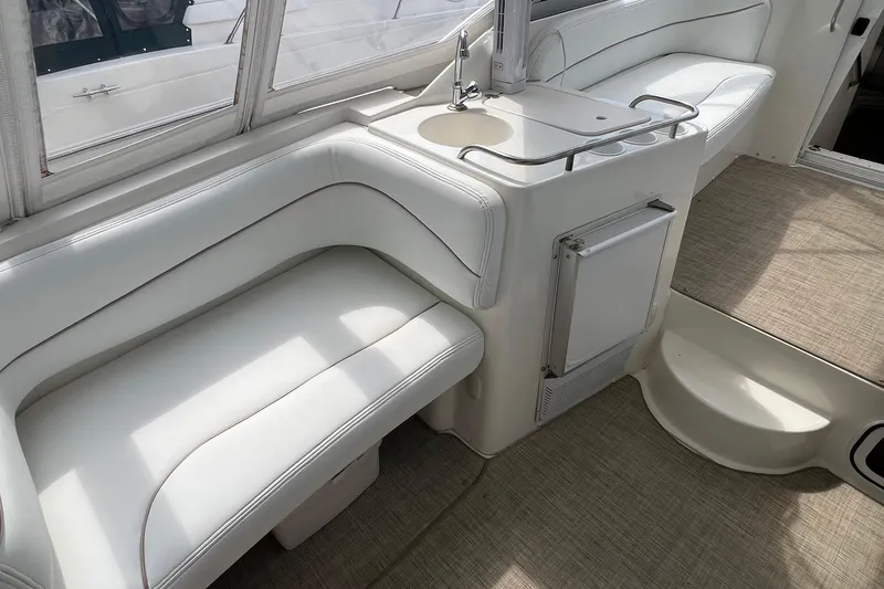 Slide: The Image of 2000 Larson 330 Cabrio boat docked, featuring a sleek white design and spacious interior. - 6