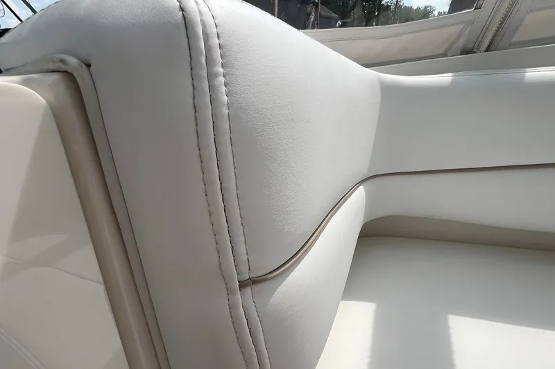 Slide: The Image of Close-up of white leather seating on a 2000 Larson 330 CABRIO boat. - 8